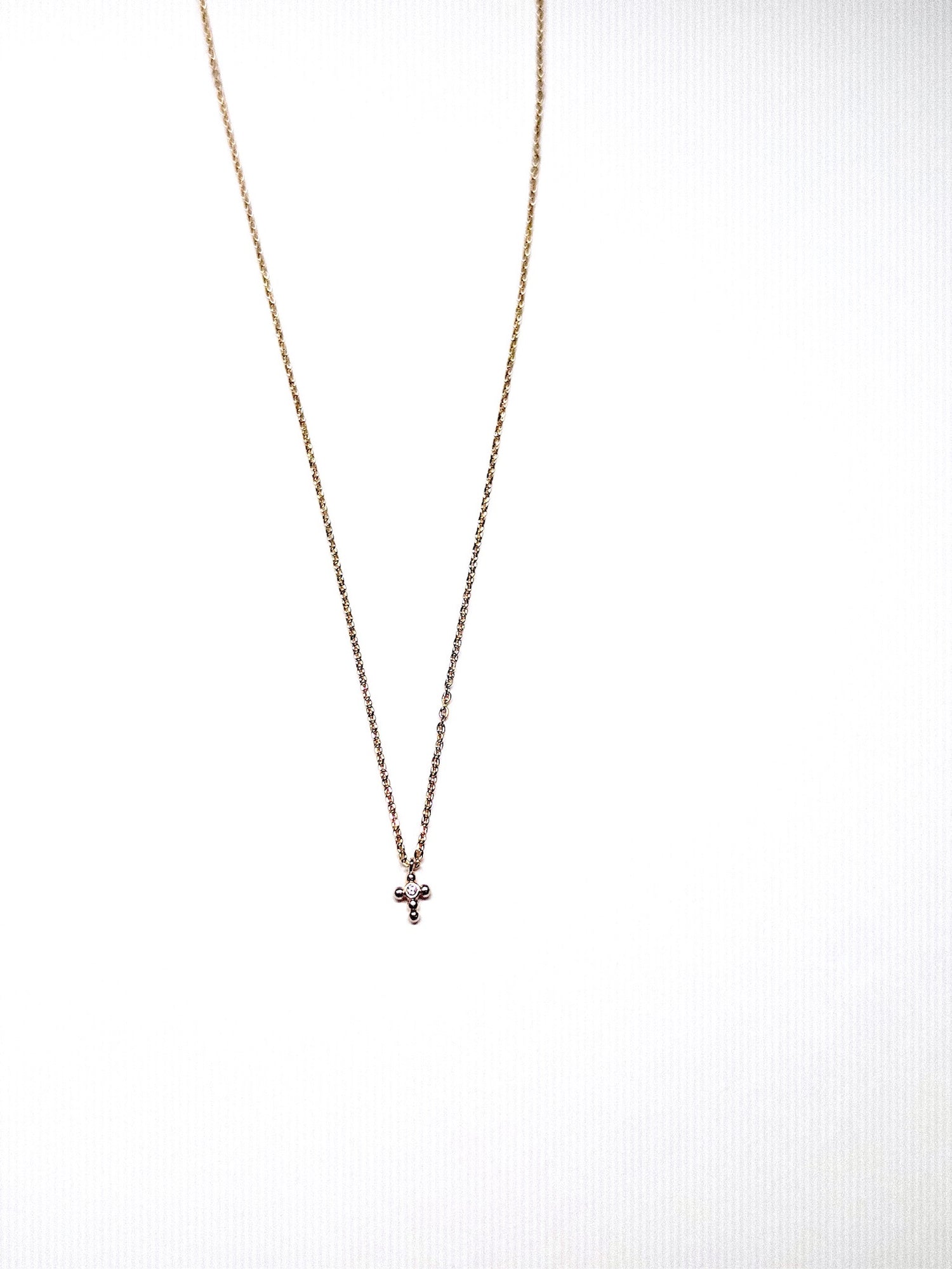 Delilah mini cross necklace in gold