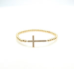 Gold beaded cross bracelet. 