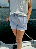 Model wearing grey anchor shorts