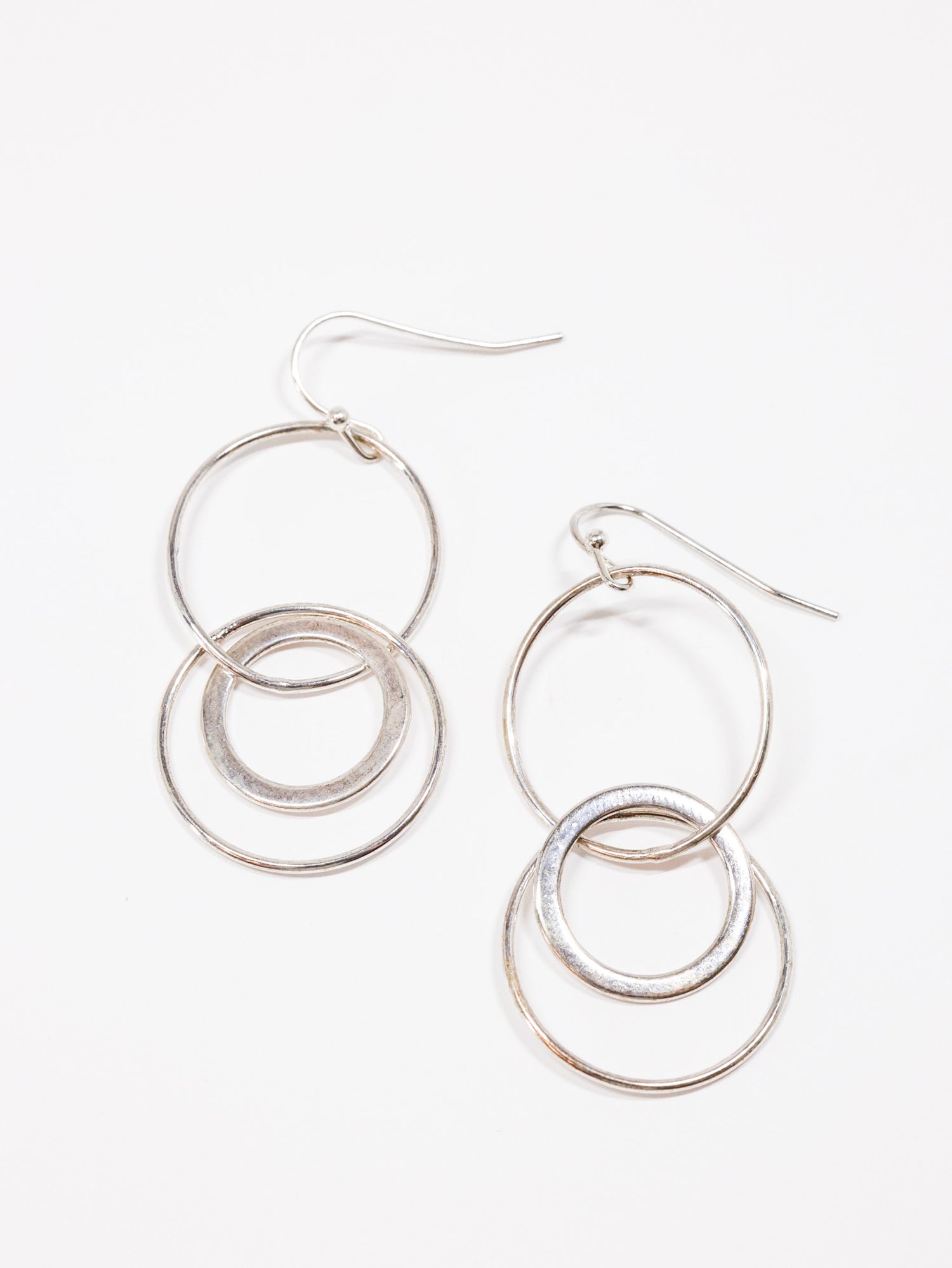 interlock hoops in silver on flat lay 