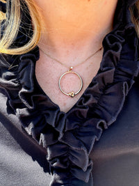 Kelly Love knot Necklace in gold shown on model