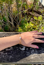 Grey pearl on a wide loop chain bracelet. adjustable on model.