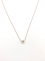 simple gold chain necklace with a pearl in the center