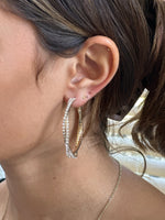 Gold sparkly hoop earring