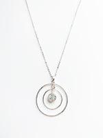 danielle long silver necklace. 2 halos around a crystal pendent.