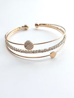 Gold cuff with a sparkly band a simple circle band and a sparkly circle band 