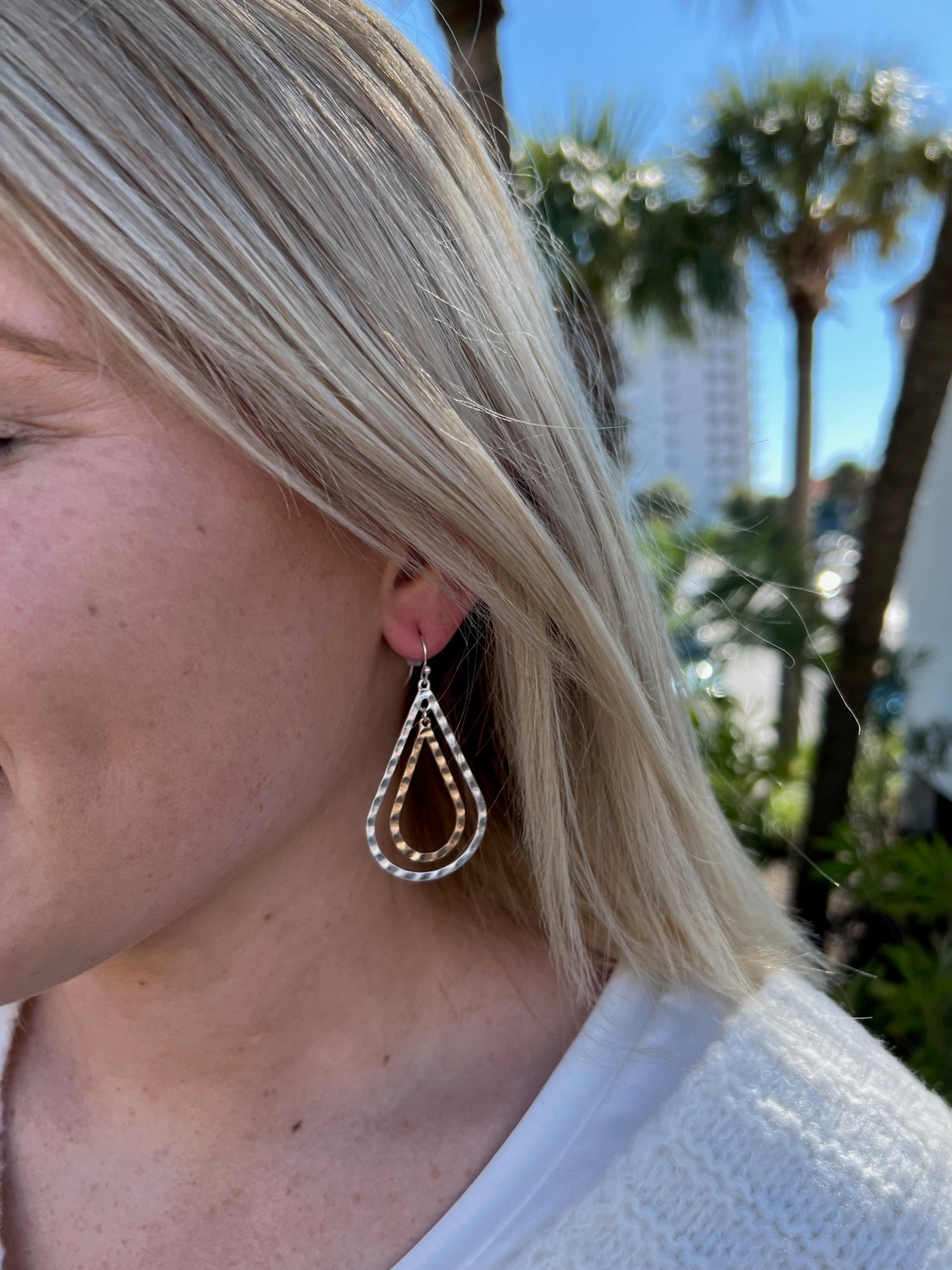 Lara Earrings shown on model. Dangle earrings with a silver and gold hanging detail