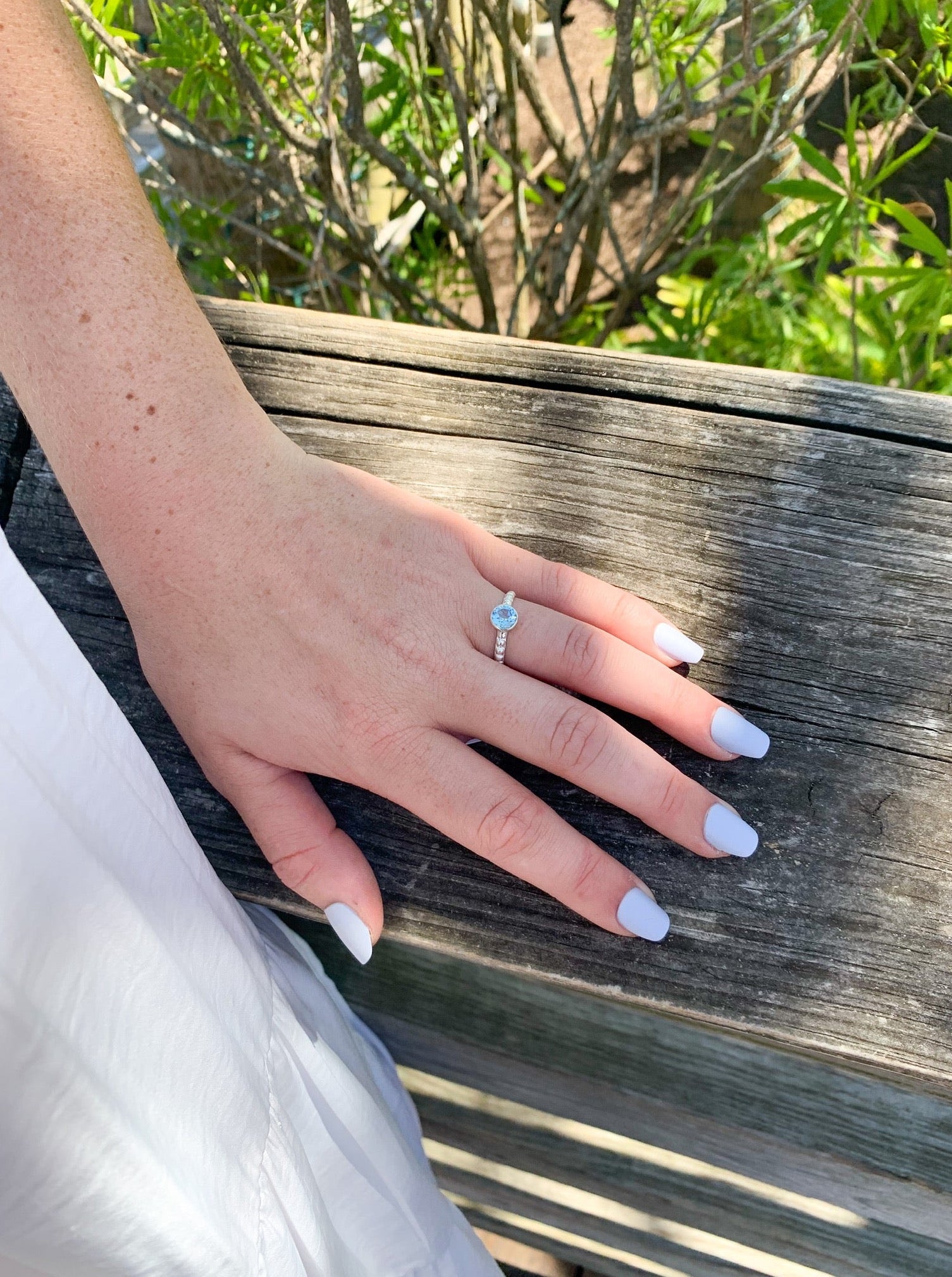 Simplicity blue topaz ring on model